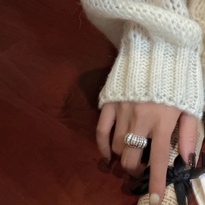 Elegant S925 sterling silver croissant ring for women styled with a cozy knit sweater