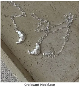 Close-up of S925 sterling silver croissant necklace with hammer texture on stone tray