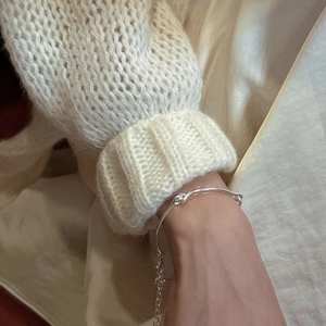 Minimalist S925 sterling silver knot bracelet with adjustable chain on a knit sleeve