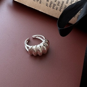 Polished S925 sterling silver croissant ring on a vintage leather and book background