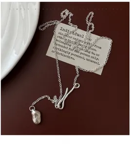 Macro view of minimalist S925 silver adjustable long chain necklace with matte pendant