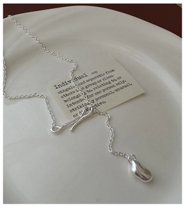 Detailed view of S925 sterling silver Y-necklace with matte irregular bar and pebble charm