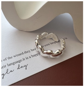 Close-up of S925 sterling silver ring with textured heart relief and high polish finish