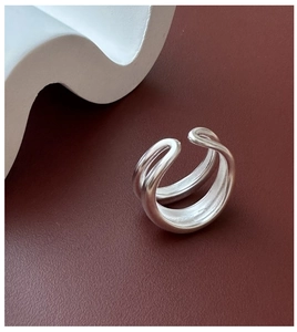 Macro view of minimalist double-layer matte sterling silver open ring on textured surface