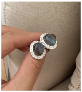 Detailed view of vintage S925 silver stud earrings with oval labradorite and braided border