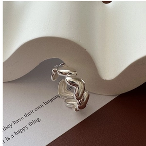 Macro shot of silver S925 heart ring with elegant irregular wave texture details