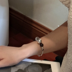 Minimalist S925 sterling silver beaded bracelet with glass and brown beads on a wrist