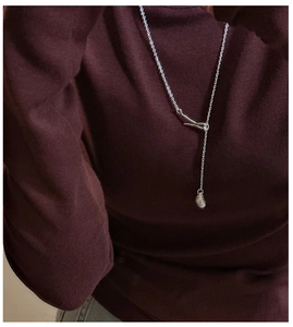 Detail of S925 sterling silver matte lariat necklace with organic irregular pendant charm