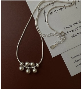 Macro shot of S925 sterling silver beads pendant with hallmark and snake chain detail