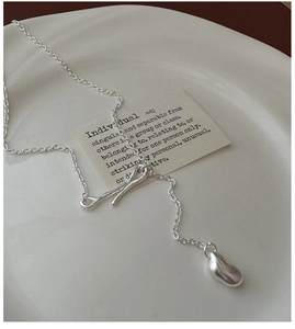 Close-up of S925 silver necklace with liquid metal droplet and matte toggle clasp