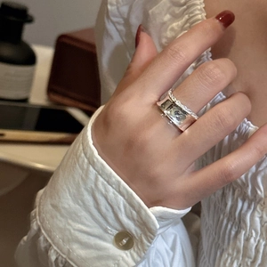 Minimalist S925 sterling silver wide band ring with textured edges worn on finger