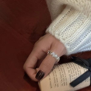 Minimalist S925 sterling silver croissant twist ring on model hand with cozy sweater