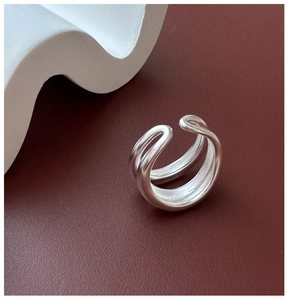 Detail of S925 sterling silver double-layered matte ring on a decorative wave base