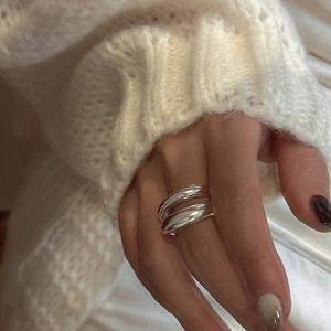 Polished double layer S925 sterling silver ring shown on hand with cozy knit background