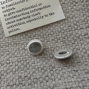 Vintage S925 sterling silver stud earrings featuring round labradorite stone on textured fabric