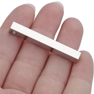 Minimalist stainless steel bar pendant necklace with brushed silver finish held by hand