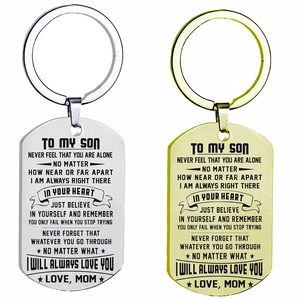 Dettaglio di portachiavi dog tag in acciaio inossidabile argento e oro con citazioni incise