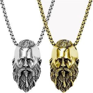 Detail of Viking warrior pendants in gold and silver finish with textured beard details