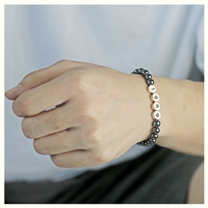 Personalized birth year bracelet with 1989 engraved beads and dark hematite stones