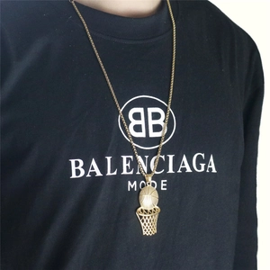Detailed view of a gold basketball hoop pendant with a ball on a bead chain