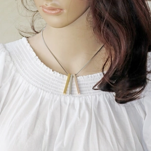 Three-color titanium steel column pendant necklace set on a model in gold, silver and rose gold