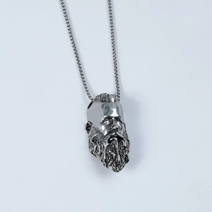 Macro detail of men's stainless steel Viking warrior pendant with vintage silver finish