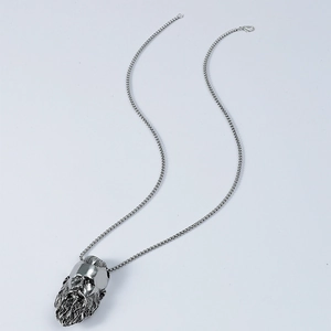 Macro shot of vintage stainless steel bearded warrior head pendant with ball chain