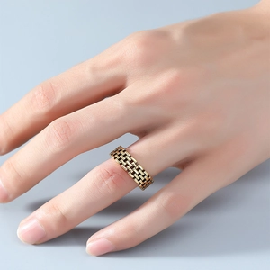 Close-up of vintage gold brick link ring showing intricate mesh texture on finger