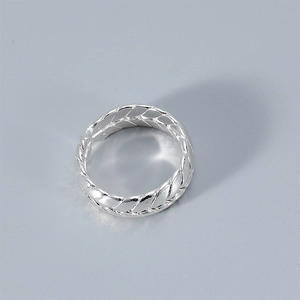 Detail shot of silver braided wheat pattern adjustable ring with metallic texture