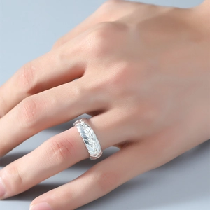 Detail of silver wheat ear engraved adjustable ring worn on finger for a stylish texture
