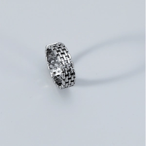 Detailed view of open ring with brick pattern and vintage silver chain texture