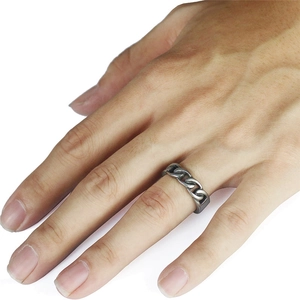 Close-up of vintage cuban link chain ring in retro silver on a man's middle finger