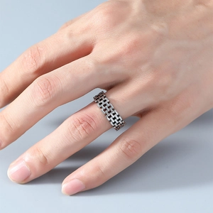 Macro shot of retro braided grid texture ring in oxidized silver on finger