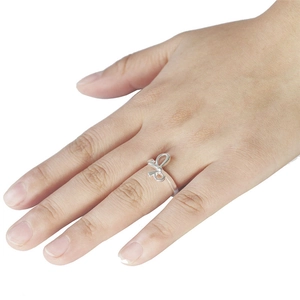 Elegant silver bow-shaped adjustable open ring shown on a hand with a minimalist design