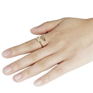 Adjustable gold devil wing ring featuring arrow tail design worn on a finger
