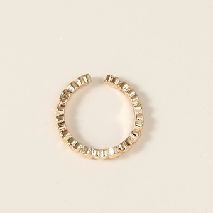 Vue détaillée d'une bague dorée ajustable avec anneau texturé aux détails perlés