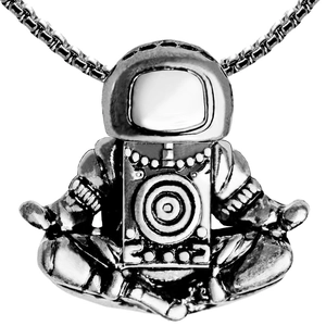 Macro shot of silver meditating astronaut pendant with detailed mechanical finish