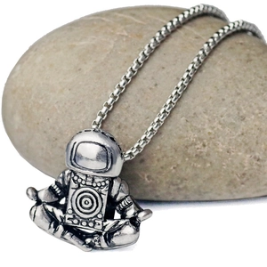 Vintage silver astronaut pendant necklace in meditation pose with a box chain