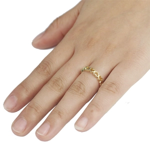 Elegante anello dorato con cuori intrecciati per donna, indossato sull'indice su sfondo bianco