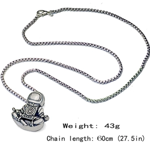 Detail shot of vintage astronaut pendant necklace showing 60cm chain length and 43g weight