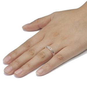 Anello traforato con cuori in argento sterling indossato al dito in stile minimalista