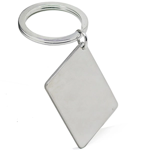 Macro detail of polished stainless steel rhombus pendant on a silver keychain loop