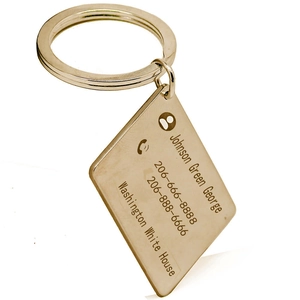 Macro view of a personalized rectangle metal keychain with custom name and address engraving