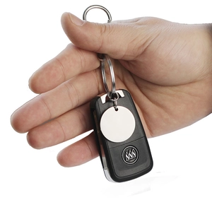 Custom Buick key shell with metal ring and blank round tag held in hand on white background