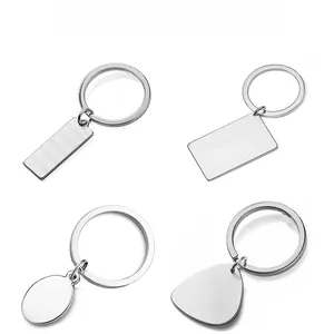 Macro view of four geometric stainless steel keychains with brushed silver finish for engraving