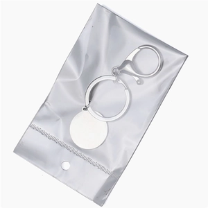 Custom silver stainless steel keychain set with round tag and lobster clasp in packaging