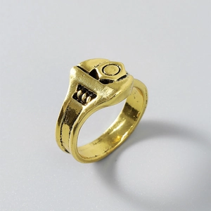 Detail of adjustable wrench ring showing the intricate golden screw and industrial design