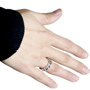 Detail of adjustable silver Cuban link chain ring worn on finger in punk style