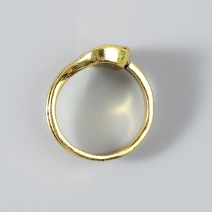 Detailed top view of a gold punk wrench ring with a smooth polished metallic finish