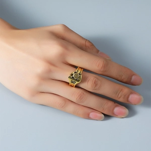Close-up of steampunk style golden hex nut ring featuring a hollow heart and industrial design
